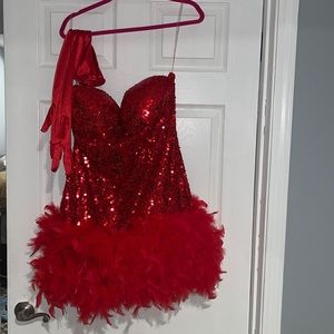 Red sparkly dress with a feather trim